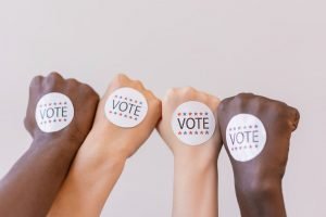 Vote stickers on the hands on people: how to target primary voters