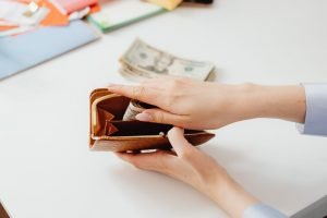 Person holding their wallet: how to fight donor fatigue