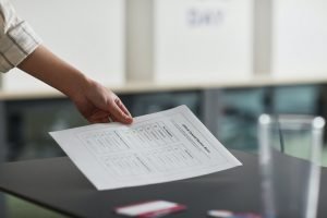 Person holding a poll sheet: what do political consulting firms do?